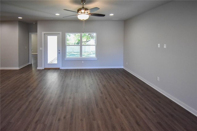 spare room featuring ceiling fan and dark hardwood / wood-style floors