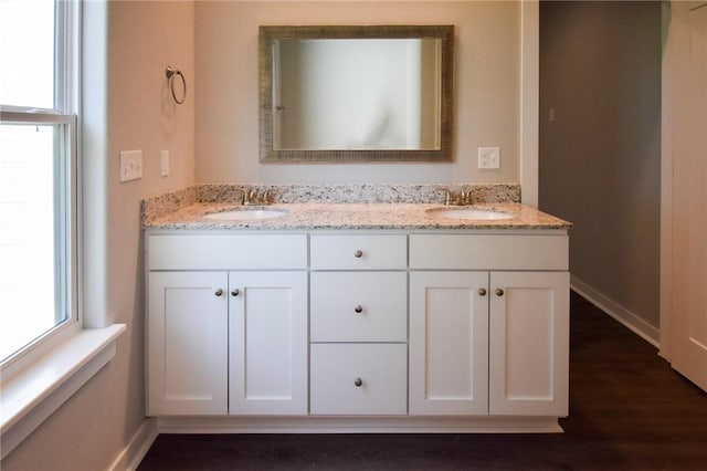 bathroom with vanity and hardwood / wood-style floors