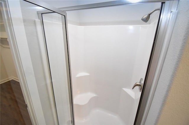 bathroom featuring wood-type flooring and walk in shower