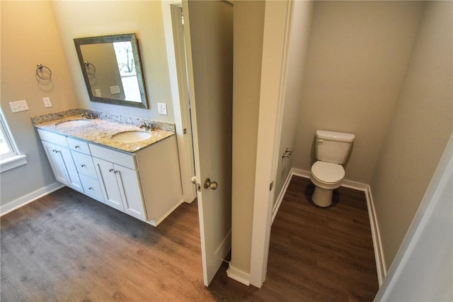 bathroom with vanity, hardwood / wood-style floors, and toilet