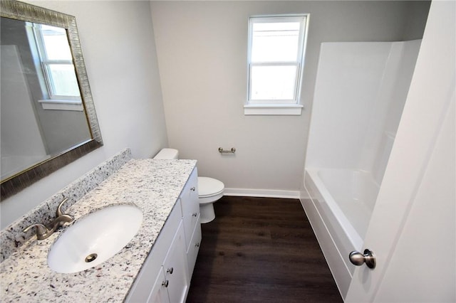 full bathroom featuring vanity, hardwood / wood-style floors, shower with separate bathtub, and toilet