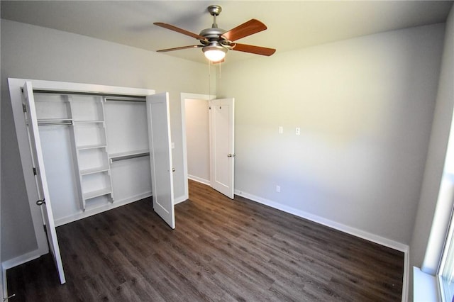 unfurnished bedroom with dark hardwood / wood-style floors, ceiling fan, and a closet