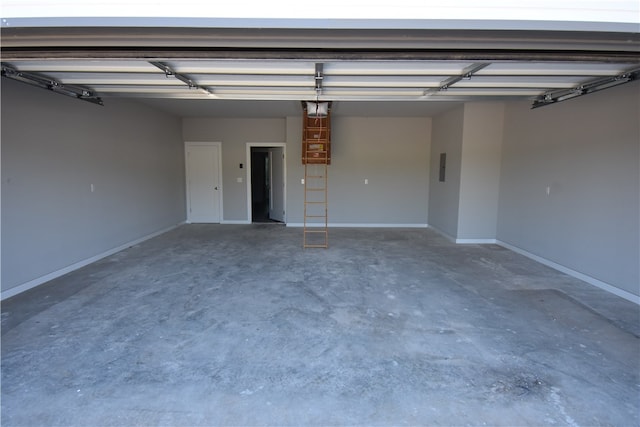 garage with a garage door opener and electric panel