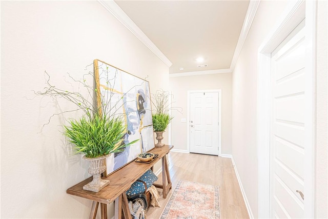 hall featuring crown molding and light hardwood / wood-style floors