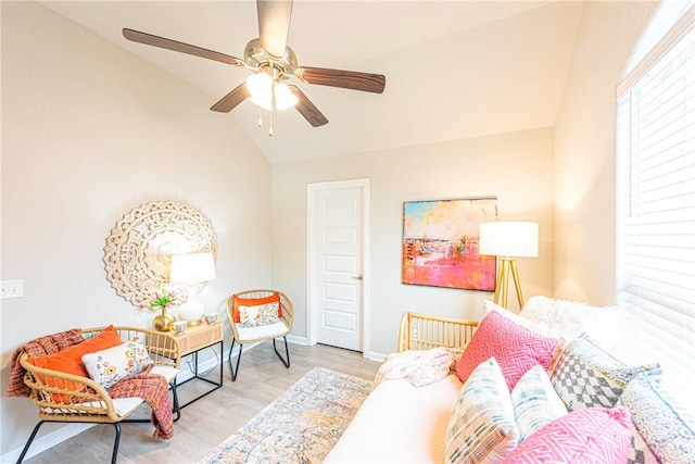 interior space with ceiling fan, light hardwood / wood-style floors, and vaulted ceiling