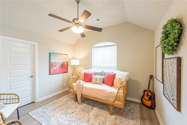 sitting room with ceiling fan, vaulted ceiling, and wood-type flooring