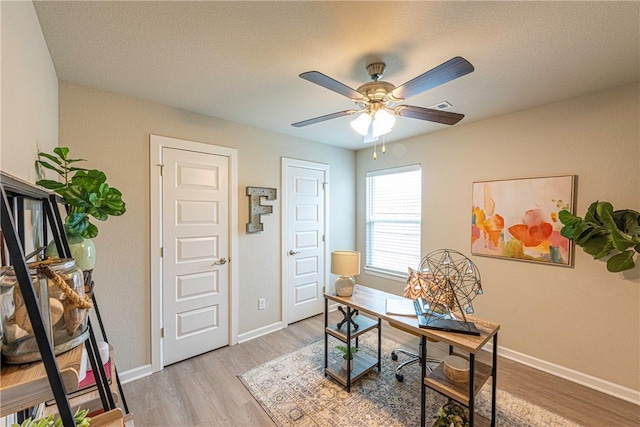 office space with ceiling fan and light wood-type flooring