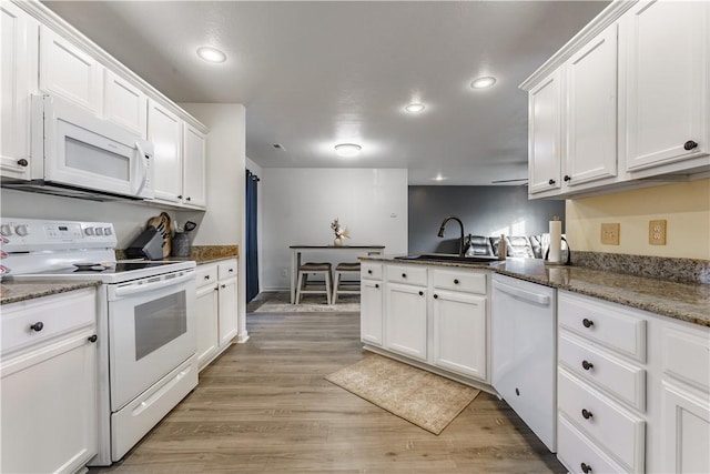 kitchen featuring sink, white cabinets, white appliances, and light hardwood / wood-style floors