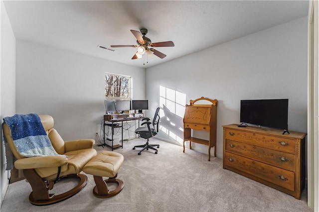 carpeted office featuring ceiling fan