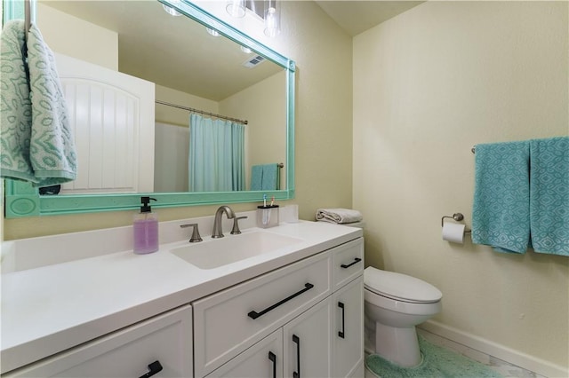 bathroom featuring vanity, curtained shower, and toilet