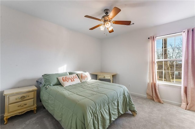 bedroom with light colored carpet and ceiling fan