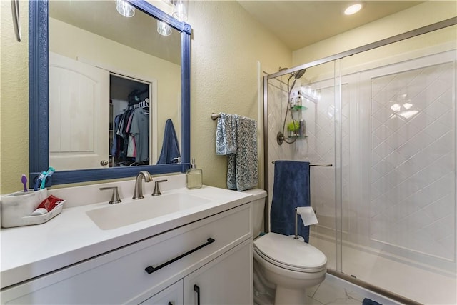 bathroom with vanity, toilet, and an enclosed shower