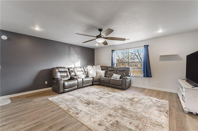 living room with light hardwood / wood-style floors and ceiling fan