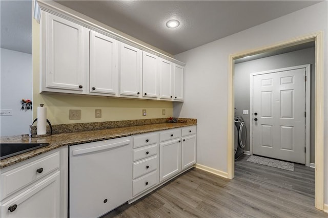 kitchen with white dishwasher and white cabinetry