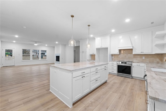 kitchen with premium range hood, open shelves, electric range, decorative backsplash, and light wood-style floors