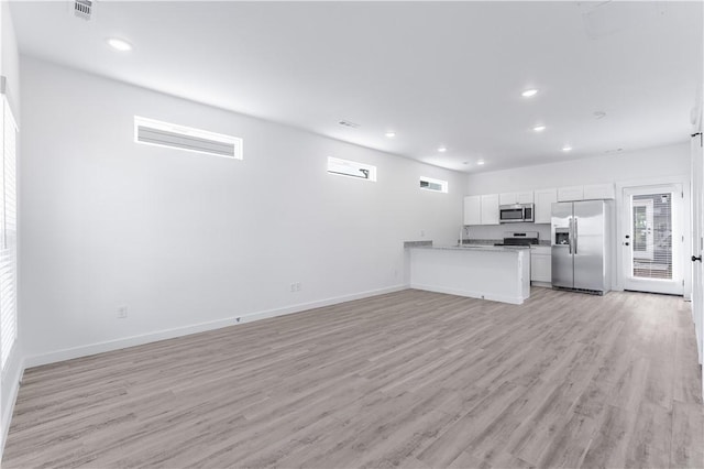 unfurnished living room featuring light wood-type flooring