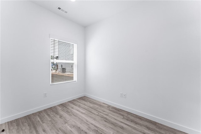 spare room with light hardwood / wood-style flooring