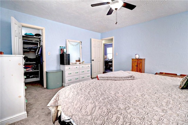 3001 Waukesha Rd, Siloam Springs, AR 72761 - carpeted bedroom with a walk in closet, a textured ceiling, a closet, and ceiling fan