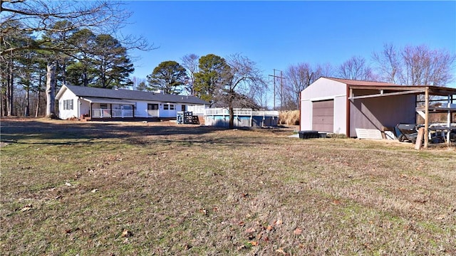 3001 Waukesha Rd, Siloam Springs, AR 72761 - view of grassy yard featuring a detached garage, an outdoor structure, and an outdoor pool