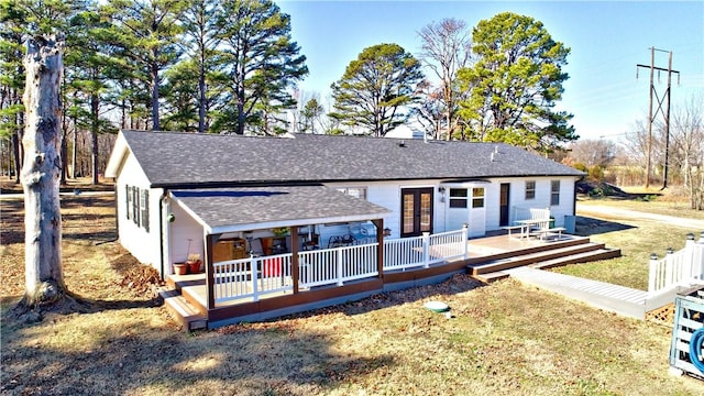 3001 Waukesha Rd, Siloam Springs, AR 72761 - back of property featuring a shingled roof, french doors, and a yard