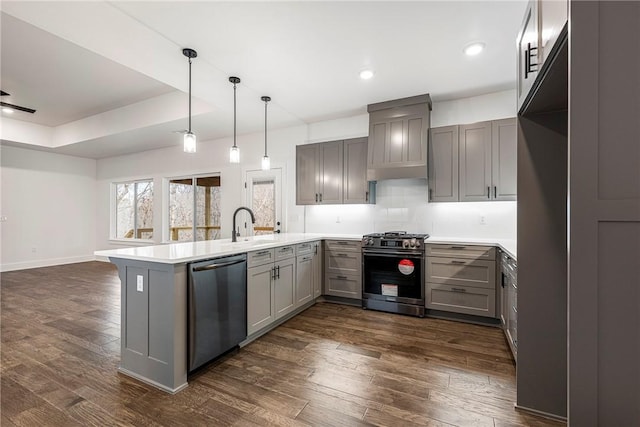 kitchen featuring gray cabinets, pendant lighting, kitchen peninsula, stainless steel appliances, and dark wood-type flooring