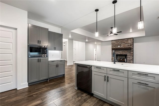 kitchen featuring sink, gray cabinets, a raised ceiling, and dishwasher