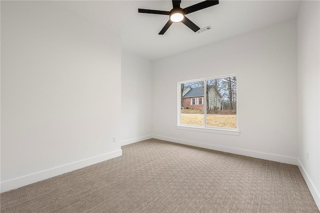 carpeted spare room with ceiling fan