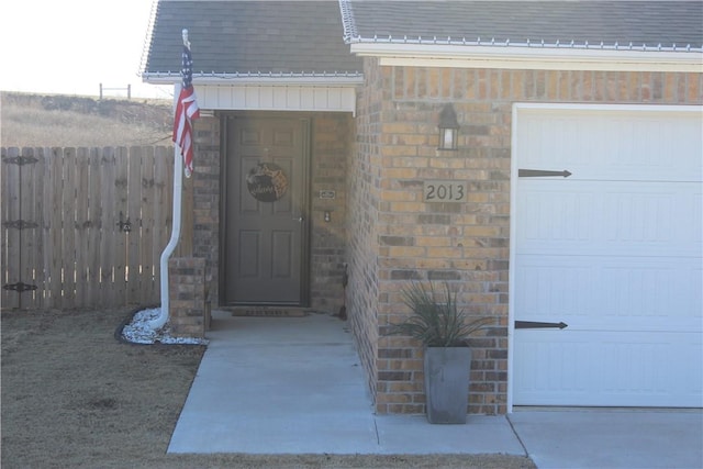 view of exterior entry featuring a garage