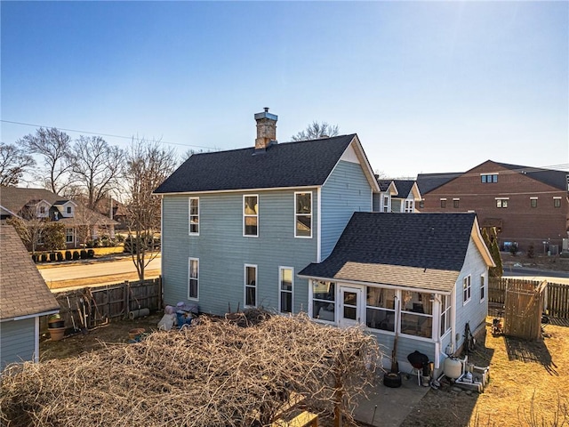 back of property with a sunroom