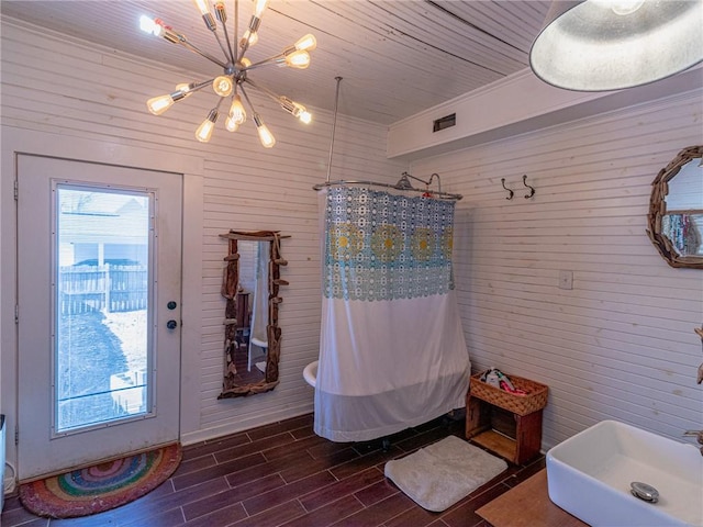 bathroom with a shower with curtain and a notable chandelier