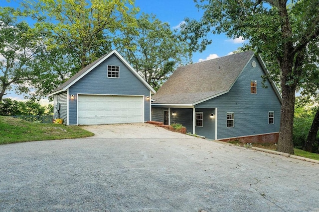 view of front of home with a garage and an outdoor structure