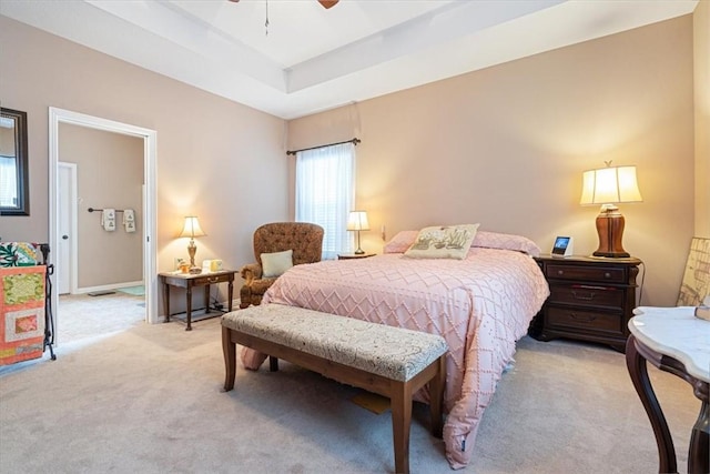 carpeted bedroom featuring a tray ceiling