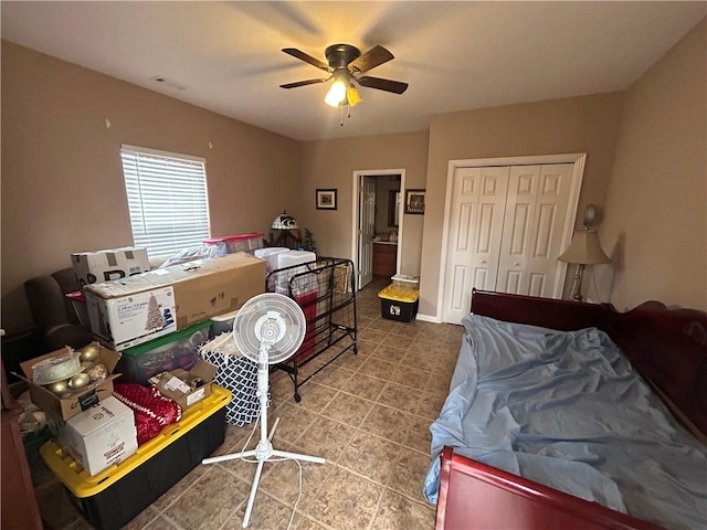 tiled bedroom featuring a closet and ceiling fan