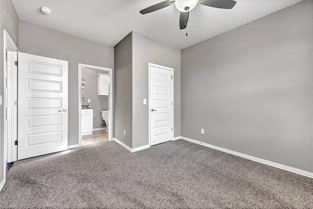 unfurnished bedroom with ceiling fan, ensuite bath, and carpet floors