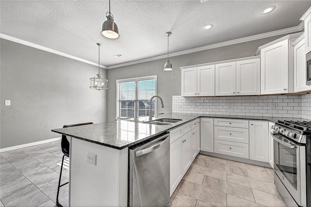 kitchen featuring pendant lighting, white cabinetry, sink, a breakfast bar area, and stainless steel appliances