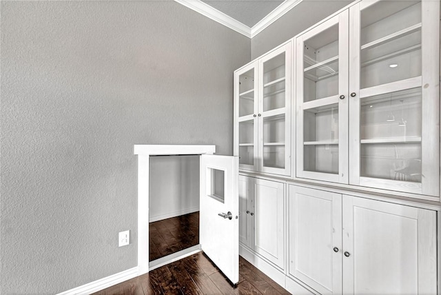 interior space featuring dark wood-type flooring and ornamental molding