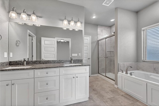 bathroom featuring vanity, tile patterned floors, and plus walk in shower