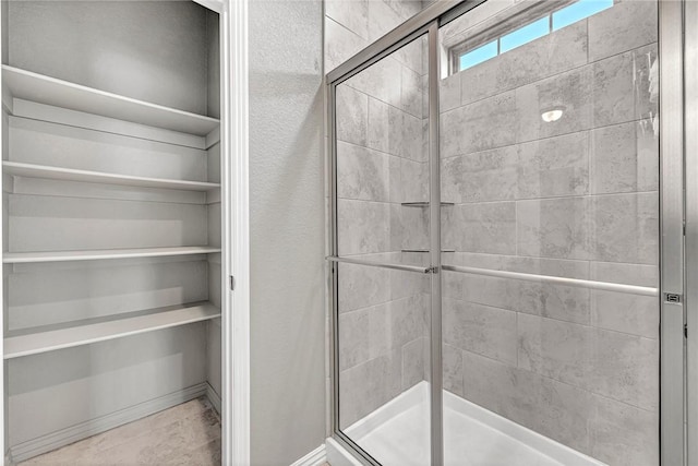 bathroom with a shower with door