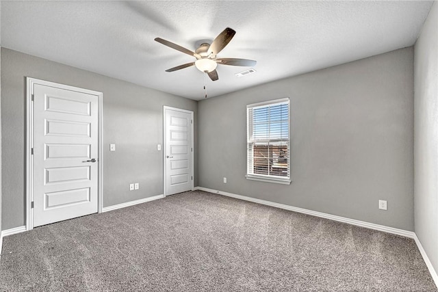 carpeted empty room with a textured ceiling and ceiling fan