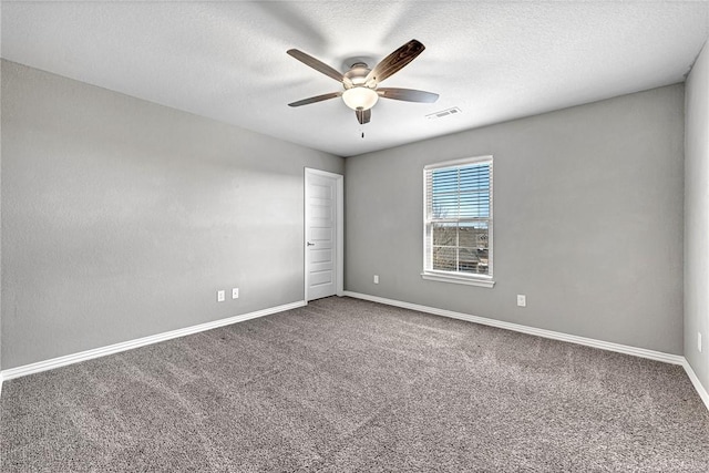 carpeted empty room featuring a textured ceiling and ceiling fan