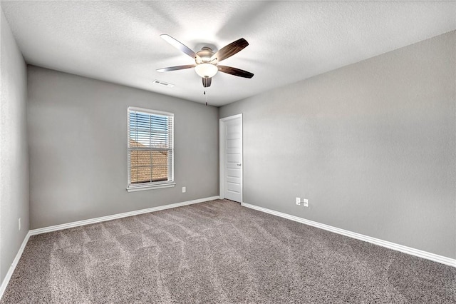 carpeted empty room with a textured ceiling and ceiling fan