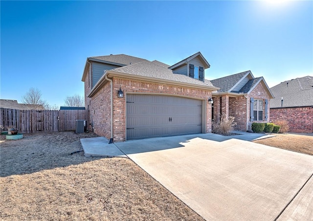 view of front of home featuring a garage and central AC