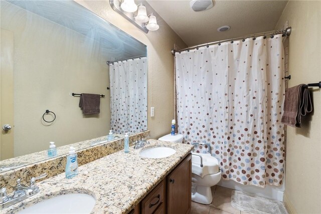 bathroom featuring tile patterned flooring, vanity, and toilet