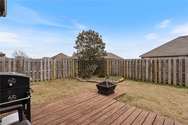 deck featuring a fire pit and a lawn