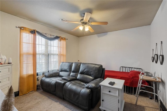 carpeted living room with ceiling fan