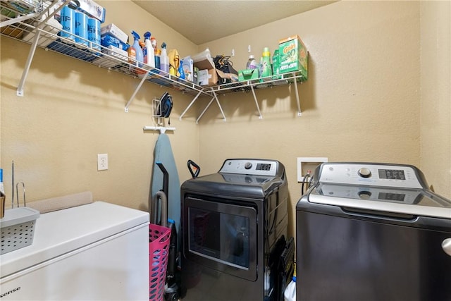 washroom with independent washer and dryer