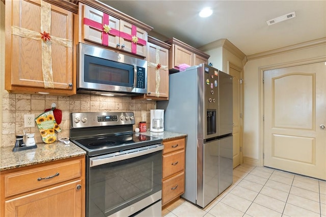 kitchen featuring tasteful backsplash, ornamental molding, light tile patterned floors, light stone counters, and stainless steel appliances