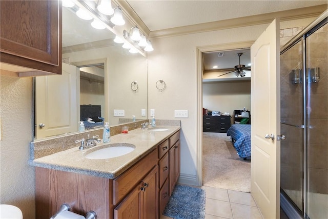 bathroom with vanity, an enclosed shower, ceiling fan, crown molding, and tile patterned floors