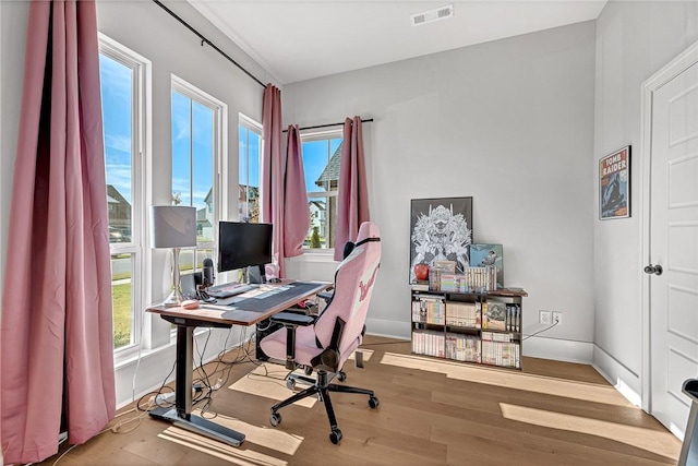 office area with hardwood / wood-style flooring and a healthy amount of sunlight