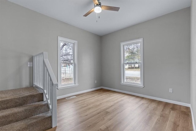 unfurnished room with ceiling fan and light wood-type flooring